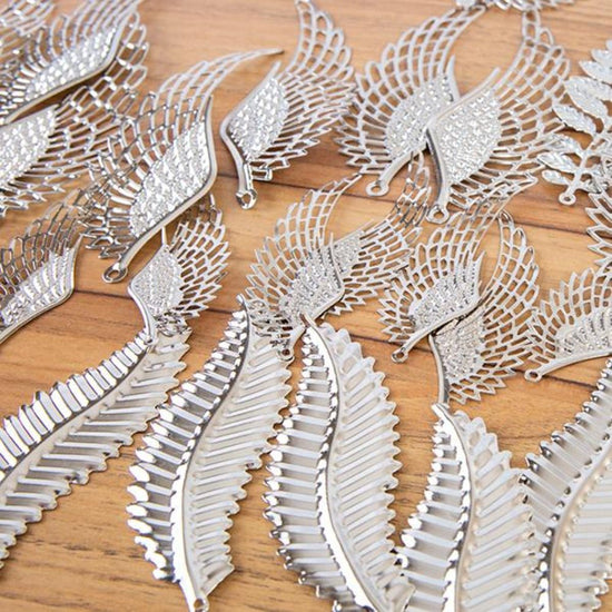 537945: Craft Buddy Set of 100 Filigree Feather, Flourish and Leaf Embellishments